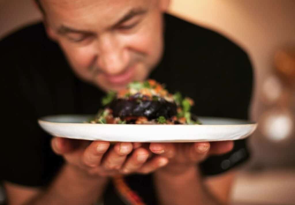 Chef CrissCasperGross presents a plate of delicious plant-based food.